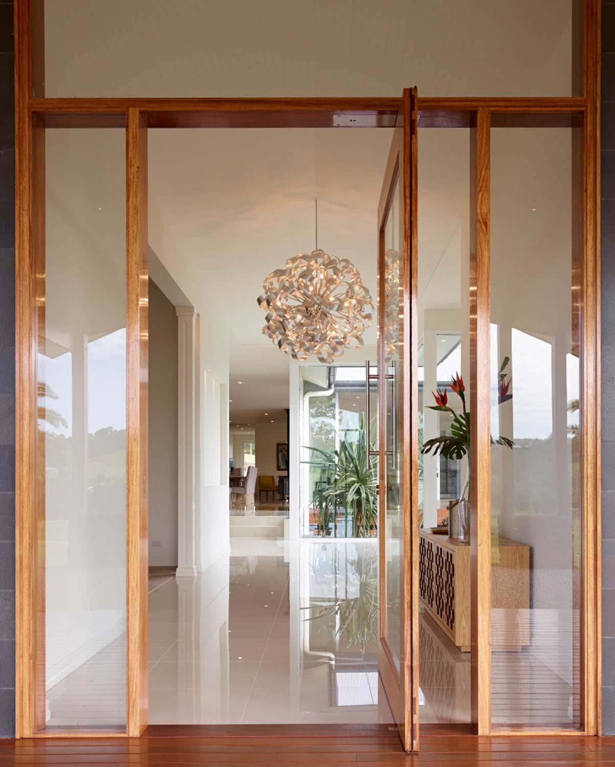 large glass pivot door leading into the house
